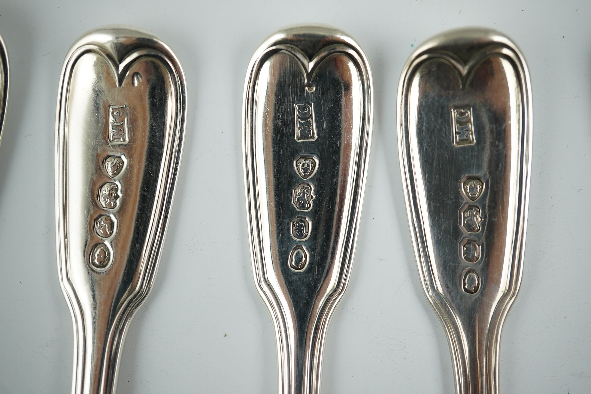 Two sets of six William IV silver fiddle and thread pattern teaspoons, one with engraved crest, William Chawner II, London, 1831 and Mary Chawner, London, 1836